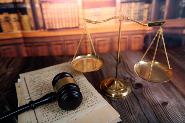 justice and law conceptMale judge in a courtroom on wooden table and Counselor or Male lawyer working in office Legal law advice and justice concept