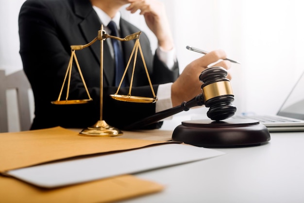 Justice and law conceptMale judge in a courtroom on wooden table and Counselor or Male lawyer working in office Legal law advice and justice concept