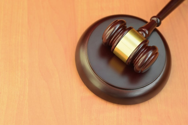 Justice mallet on wooden desk in a courtroom during a judicial trial Law concept and empty space for text Judge hammer