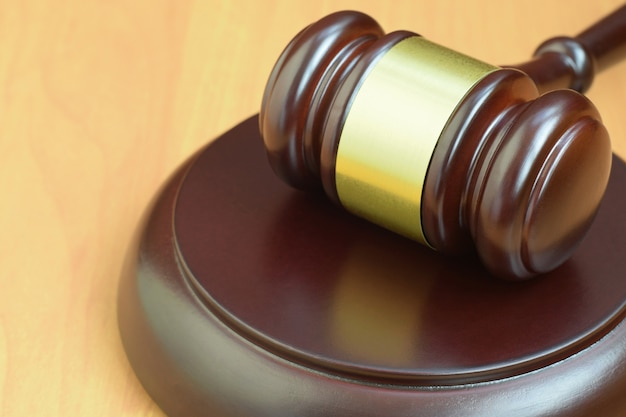 Justice mallet on wooden desk in a courtroom during a judicial trial