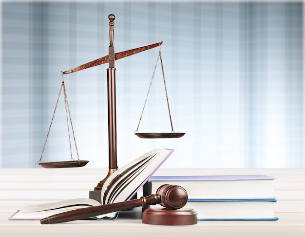 Justice Scales and books and gavel o wooden table