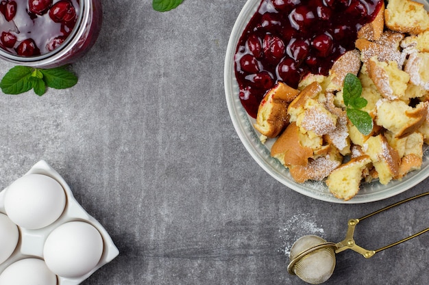 Kaiserschmarren or Kaiserschmarrn is a traditional Austrian or German sweet pancake dessert, with icing sugar and berry, cherry sauce or rote grutze jam.