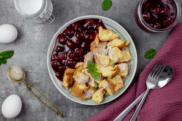 Kaiserschmarrn is a traditional Austrian or German sweet pancake dessert with cherry sauce or jam.