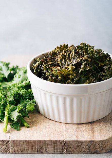 Kale chips in a ceramic bowl selective focus