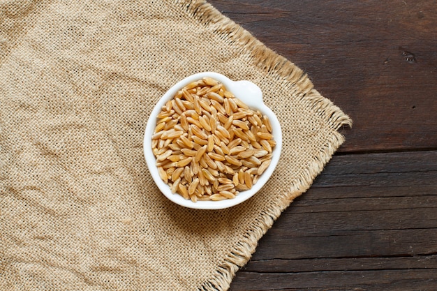 Kamut grain in a boel on wooden table top view