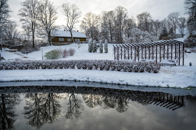 Kandava city park with a pond and tree reflections in the water on a winter day Latvia