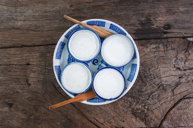 Kanom Thuay,Thai steamed coconut milk custard on wooden table