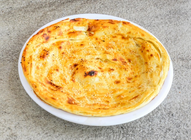 Photo karachi paratha served in plate isolated on grey background top view of pakistani and indian spices food