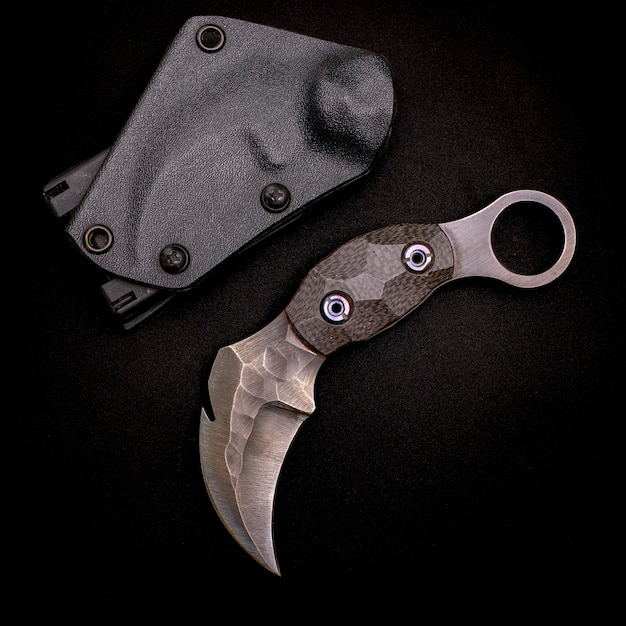 Karambit knife tactical fighter on black background