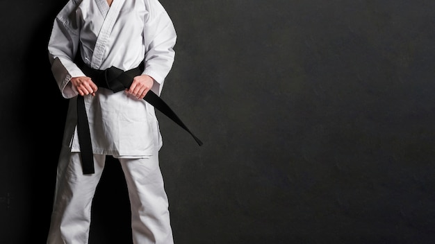 Karate fighter in uniform copy space