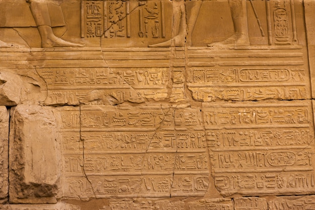 Karnak Temple, Colossal sculptures of ancient Egypt in the Nile Valley in Luxor, Embossed hieroglyphs on the wall.