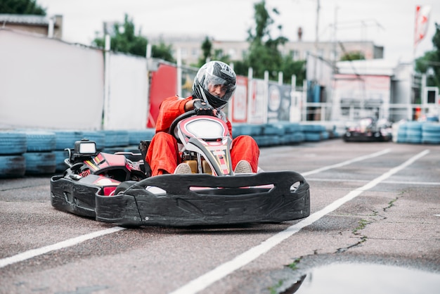 Karting racer in action, go kart competition on outdoor track. Carting championship