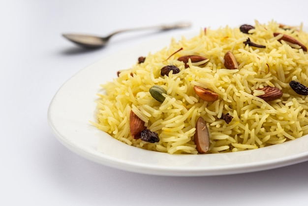 Kashmiri sweet modur pulao made of rice cooked with sugar water flavored with Saffron and dry fruits