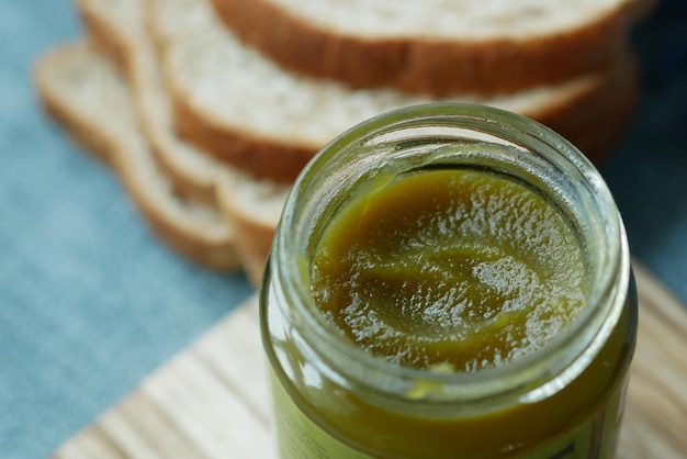 Kaya spread in a container and bread on table