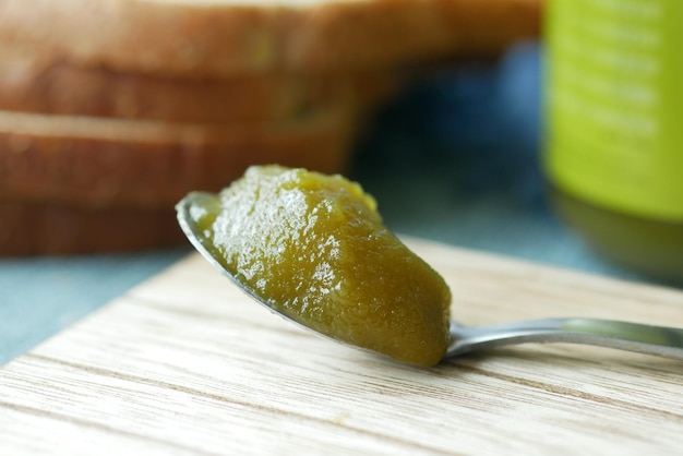 Kaya spread on a spoon on table