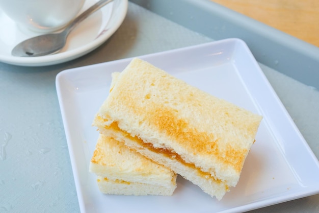 Kaya toast with a cup of tea on table