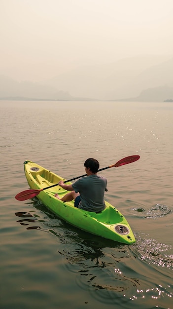 Kayak Water Sports at Lake Kayakers enjoying the beautiful sunrise walks by sea kayak or canoe at tropical bay relaxing with boat Beach summer holidays