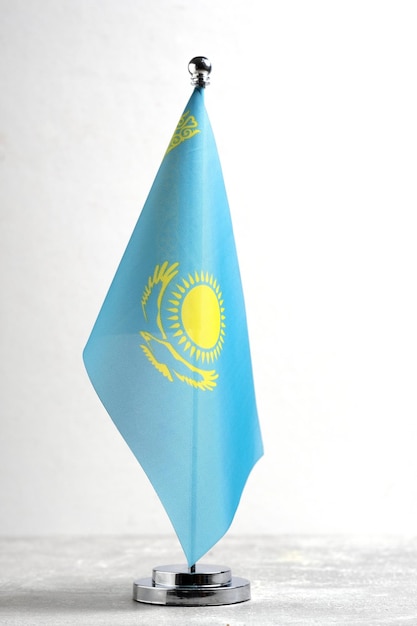 Photo kazakhstan flag on a small plastic flagpole on a white background