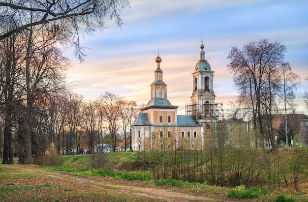 Kazan church with a bell tower in Uglich among trees without leaves