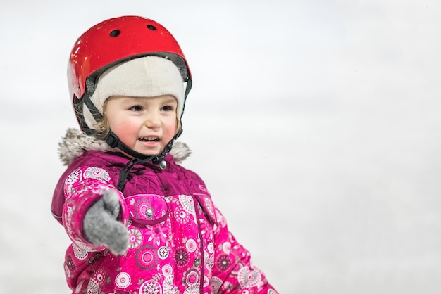 KAZAN RUSSIA 22 JANUARY 2017 Little girl in a helmet on skating rink