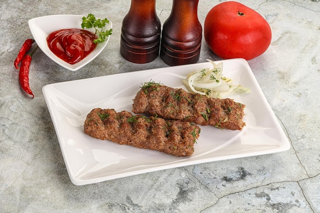 Kebab with beef served onion and sauce