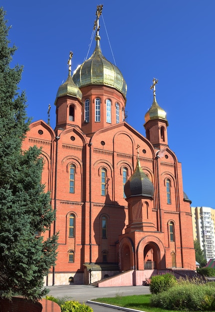 Kemerovo, Siberia, Russia-09.01.2021: Brick cathedral Orthodox church with crosses under a blue sky.