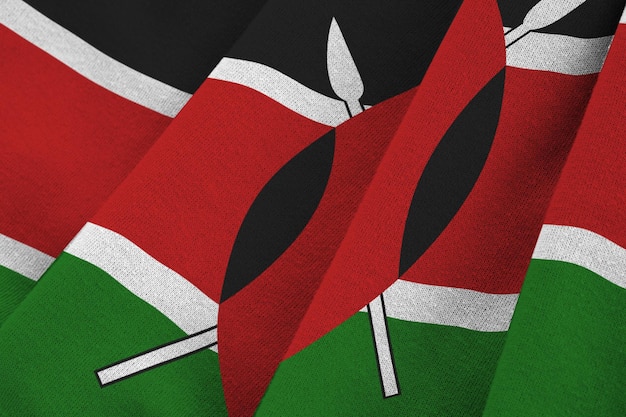 Kenya flag with big folds waving close up under the studio light indoors The official symbols and colors in banner