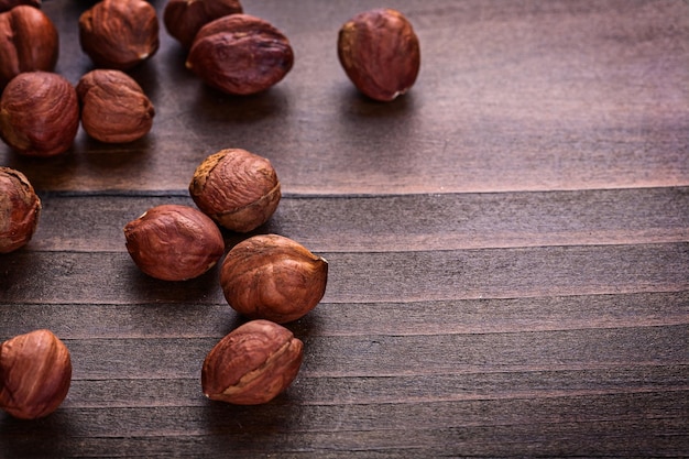 Kernels of hazelnut on vintage wooden board horizontal version food and drink concept