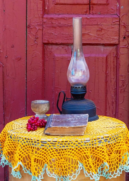 Kerosene lamp with old book on the table