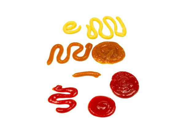 Ketchup and yellow sauce splashes isolated on white background. Top view