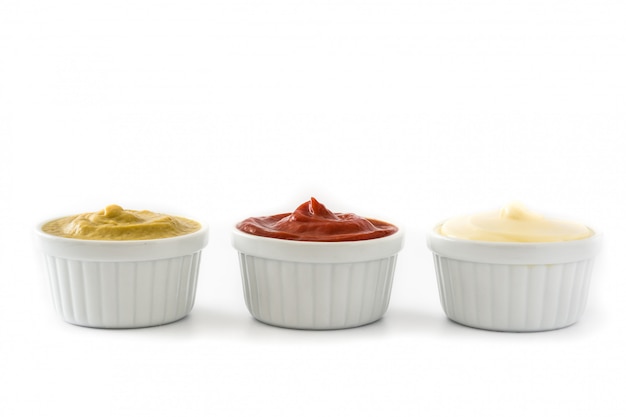 Ketchupmustard and mayonnaise in a bowls isolated on white background