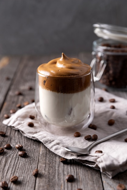 Keto dalgona whipped coffee with milk in a glass