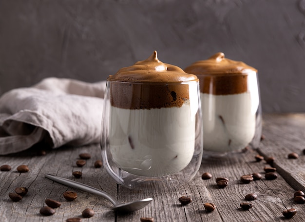 Keto dalgona whipped coffee with milk in a glass