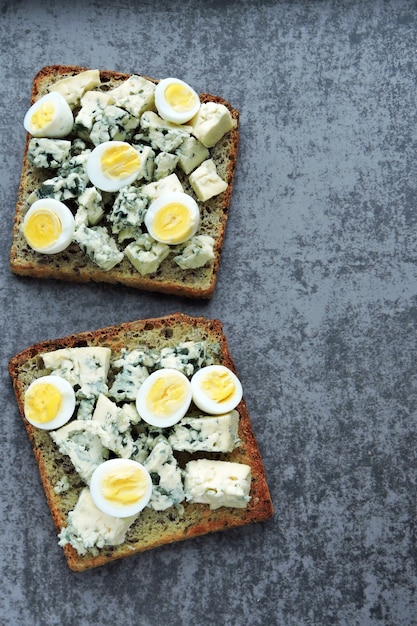 Photo keto diet. toast with blue cheese and quail eggs. keto toasts. healthy snack.