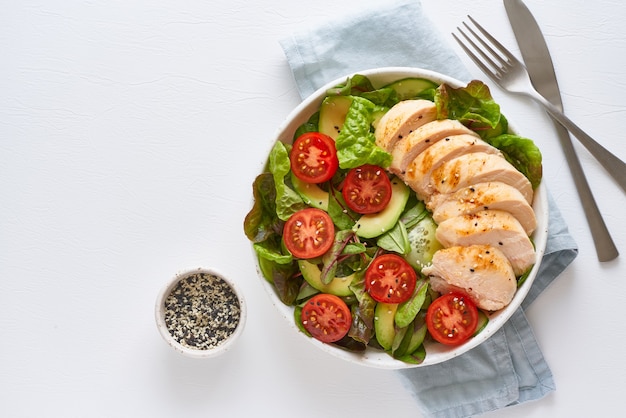 Keto salad with chicken meat sous vide, tomatoes, cucumbers, avocado