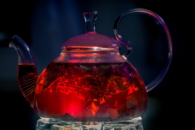 Kettle with red tea with berries and herbs