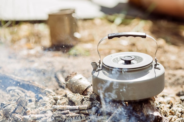 Kettle with water standing on the coals