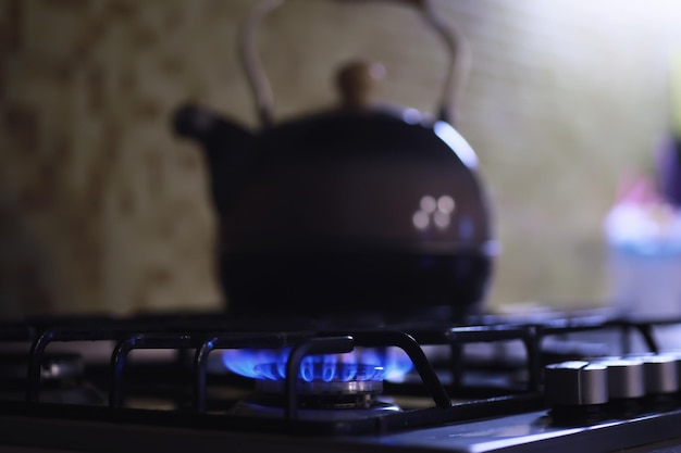 Kettle with a whistle on the gas stove Builtin gas panel The kettle is on the stoveGas crisis