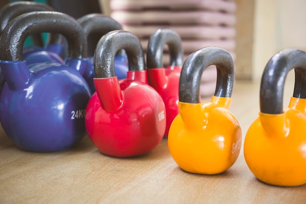 Photo kettlebell weightlifting concept colored iron kettlebell weight on wooden floor