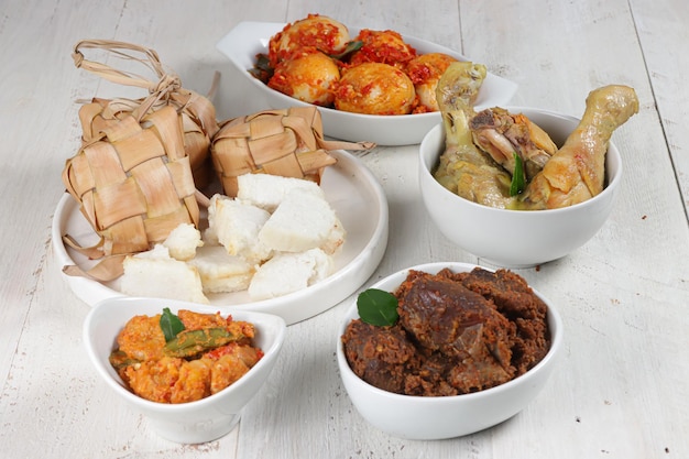 Ketupat Lebaran served with sambal goreng opor ayam sayur labu siam rendang and telur balado