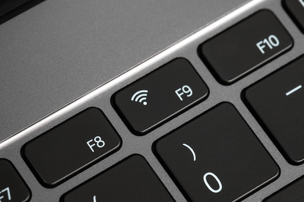 keyboard buttons and laptop fragments in black and silver background