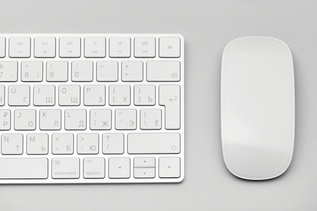 Keyboard and computer mouse closeup on a light gray background