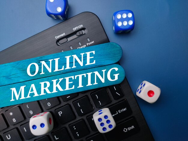 Keyboard and dice with the word ONLINE MARKETING Business concept