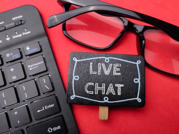 Keyboard and glasses with the word LIVE CHAT