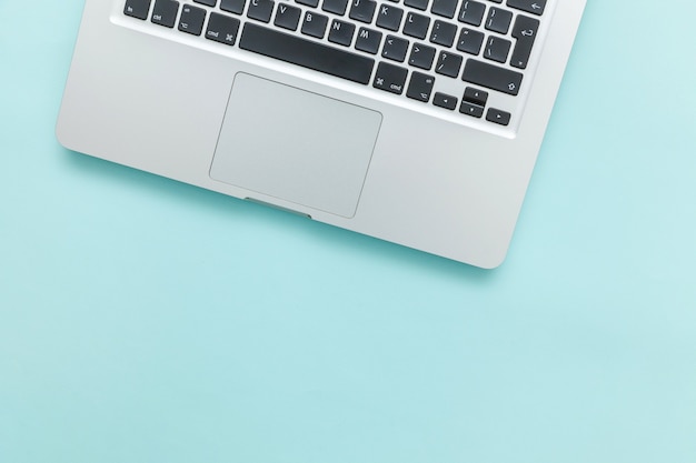 Keyboard laptop computer isolated on blue pastel desk