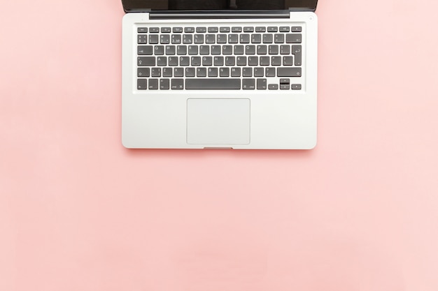 Keyboard laptop computer isolated on pink pastel desk background