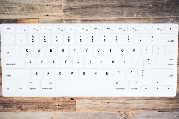 The keyboard on the vintage wooden table top view