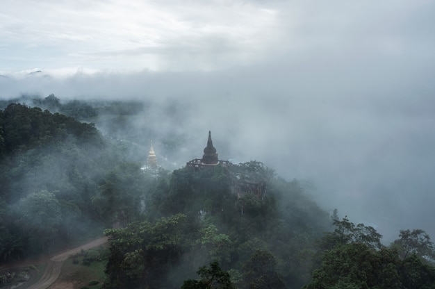 Khao Na Nai Luang Dharma Park, Ancient pagoda on foggy hill in the morning at Suratthani, Thailand