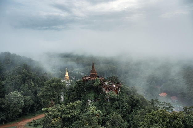 Khao Na Nai Luang Dharma Park, Ancient pagoda on foggy hill in the morning at Suratthani, Thailand