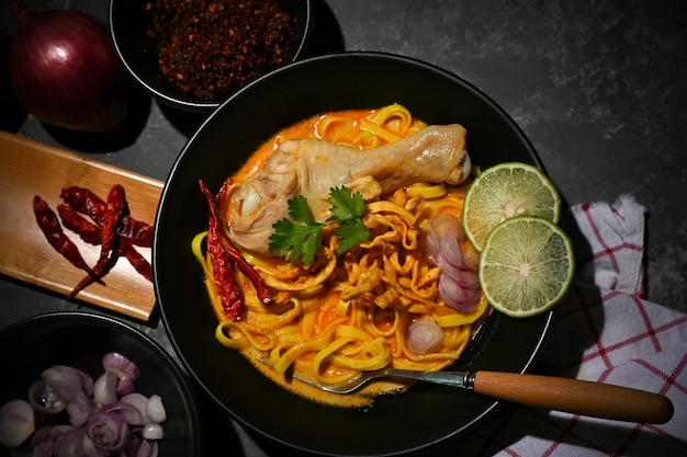 Khao Soi Kai or Unique Northern Thai curry soup with egg noodles and chicken